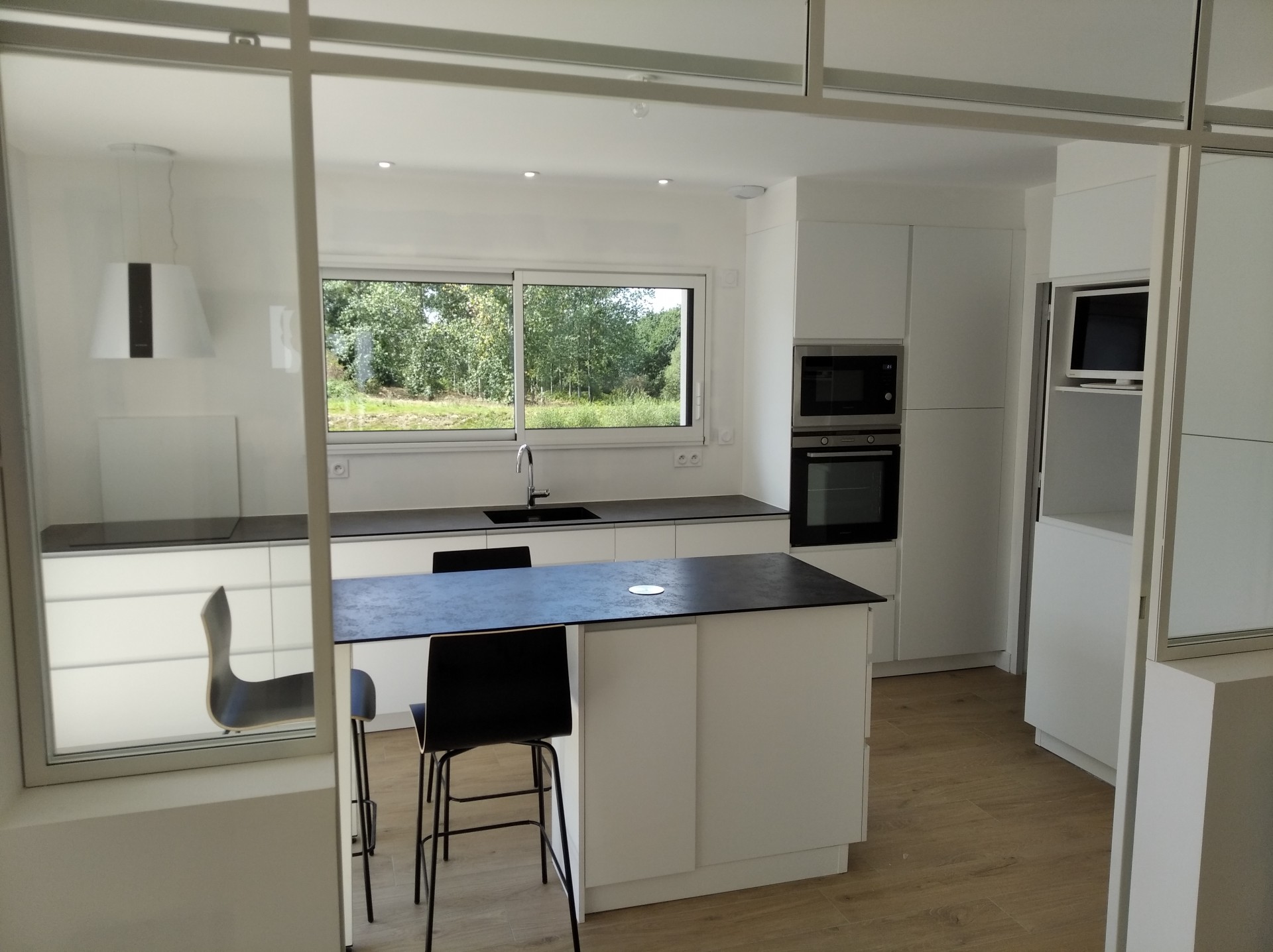 cuisine laque mat blanc, plan anthracite noir compact, verrière d'atelier